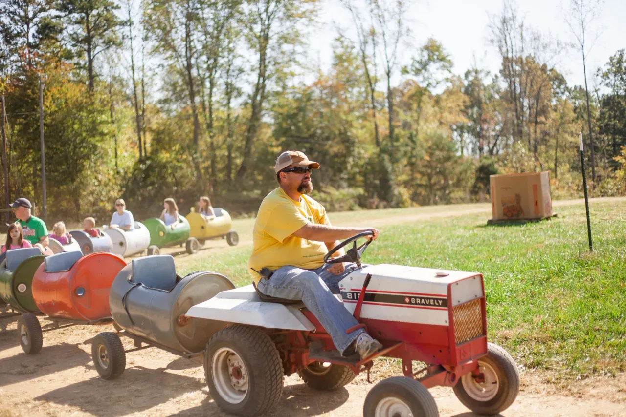 Visitors riding Alpha & Omega’s Corn Cob Express behind a tractor