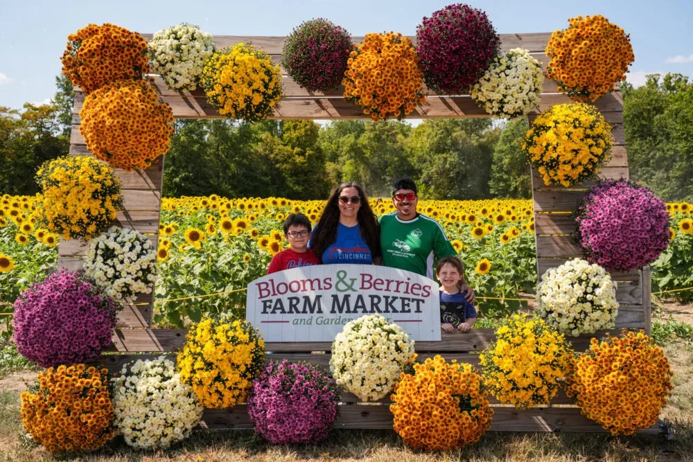 Visitors at a Blooms & Berries Farm Market photo display