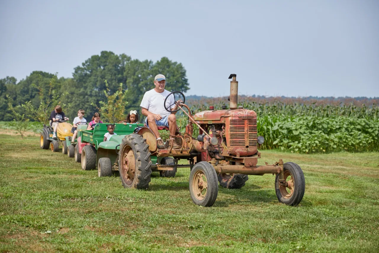 A barrel train passing the farm buildings at Christian Way Farm