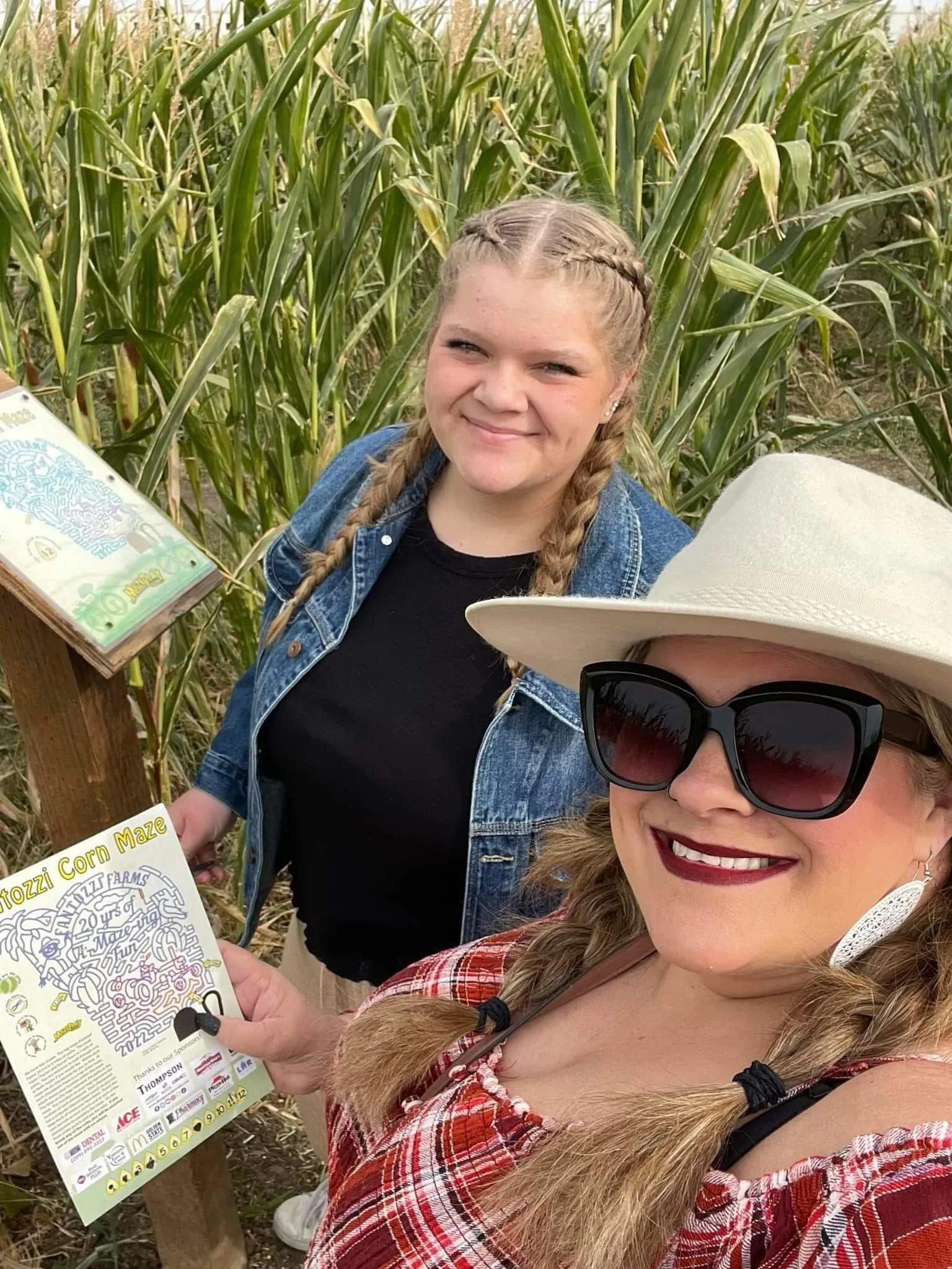 Visitors walking among the tall corn at Fantozzi Farms