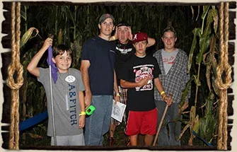 Visitors holding flashlights in the corn maze at Fruit Ridge Hayrides
