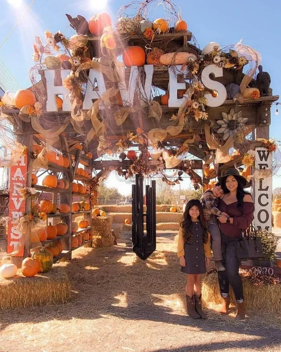 Visitors under the Historic Hawes Farms entrance arch
