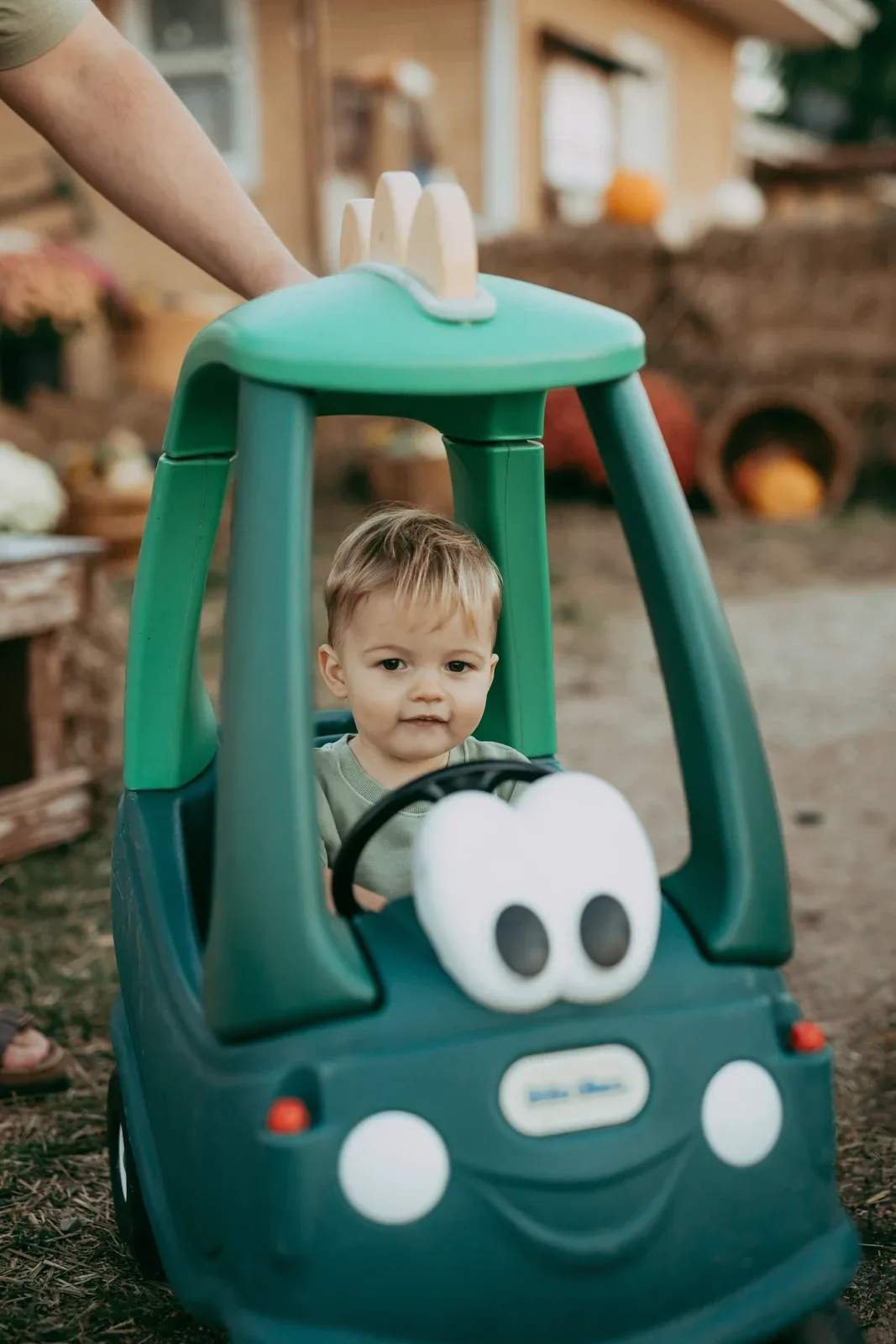 A child in a green barrel-train car at Klausmeyer Farm