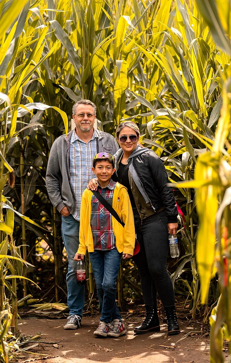 A family standing on a corn-maze path at Live Oak Canyon