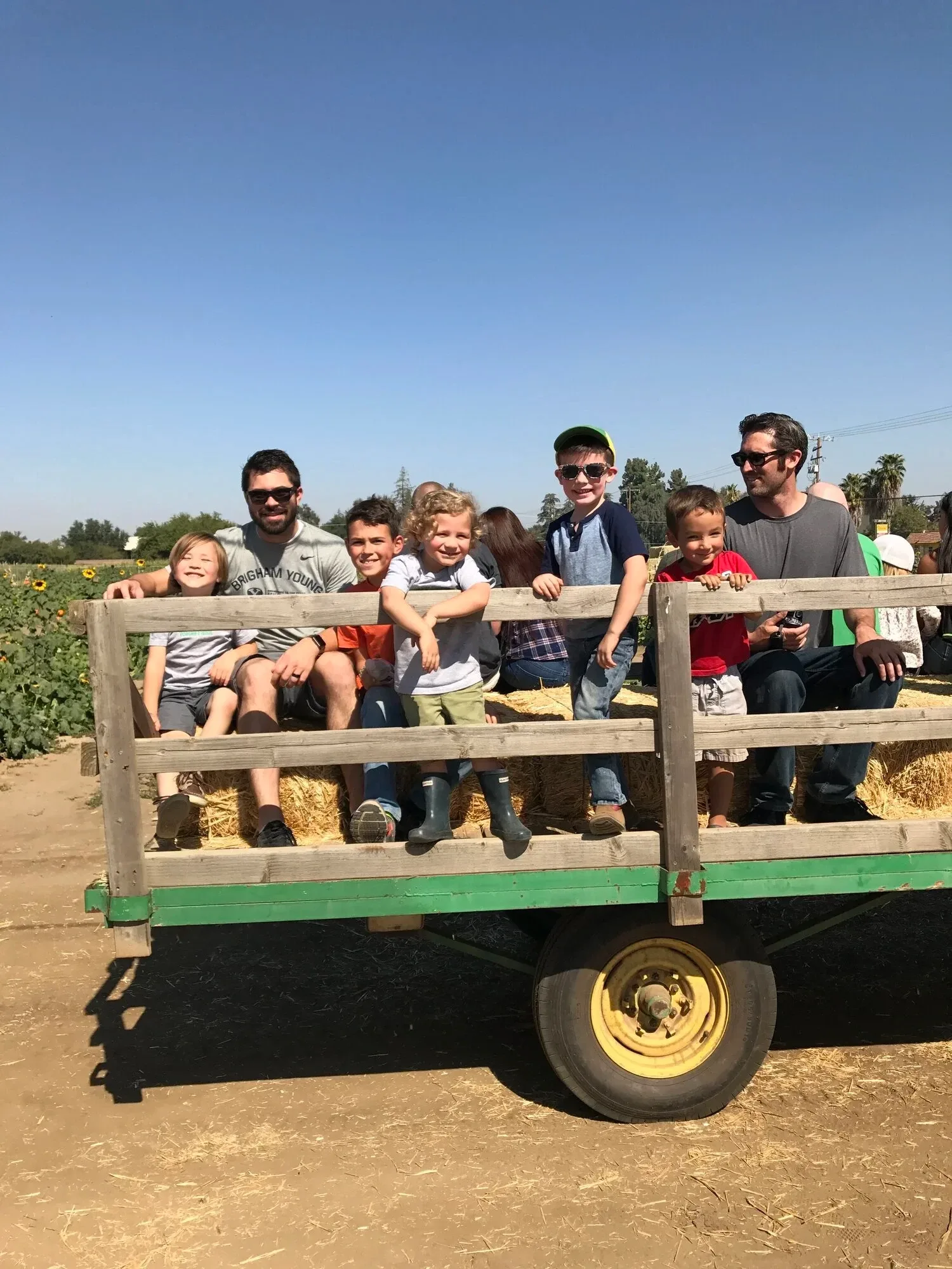 Visitors on a farm wagon ride at Vossler Farms